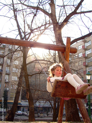 happy girl swinging in park