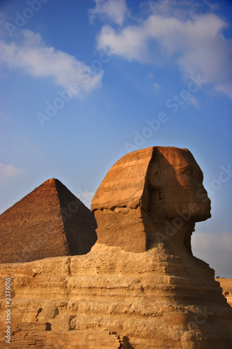 the great sphinx with the great pyramid in the background