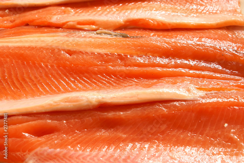 Fresh crude sliced trout filet background close-up.