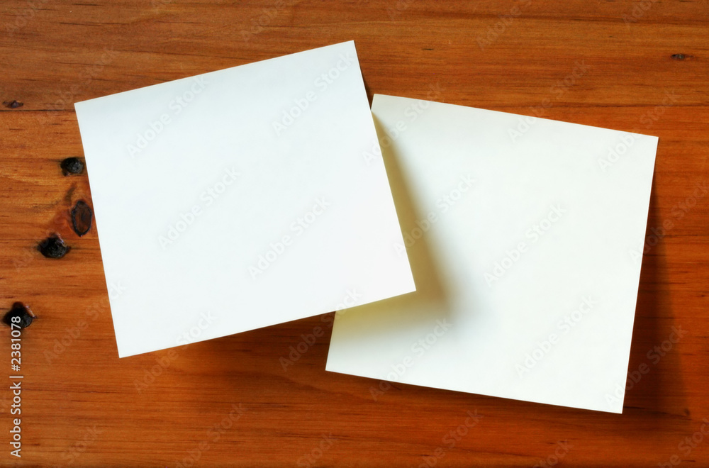 two post-it notes on timber desk two post-it notes on timber desk