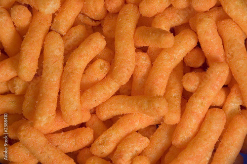 a closeup view of a pile of bright orange cheese puffs.