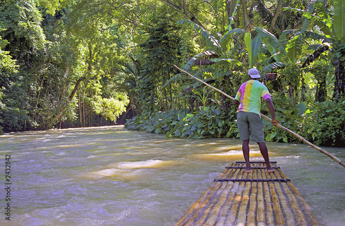 man on river raft jamaica