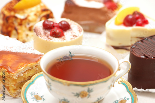 cup of tea and various cakes - shallow depth of field