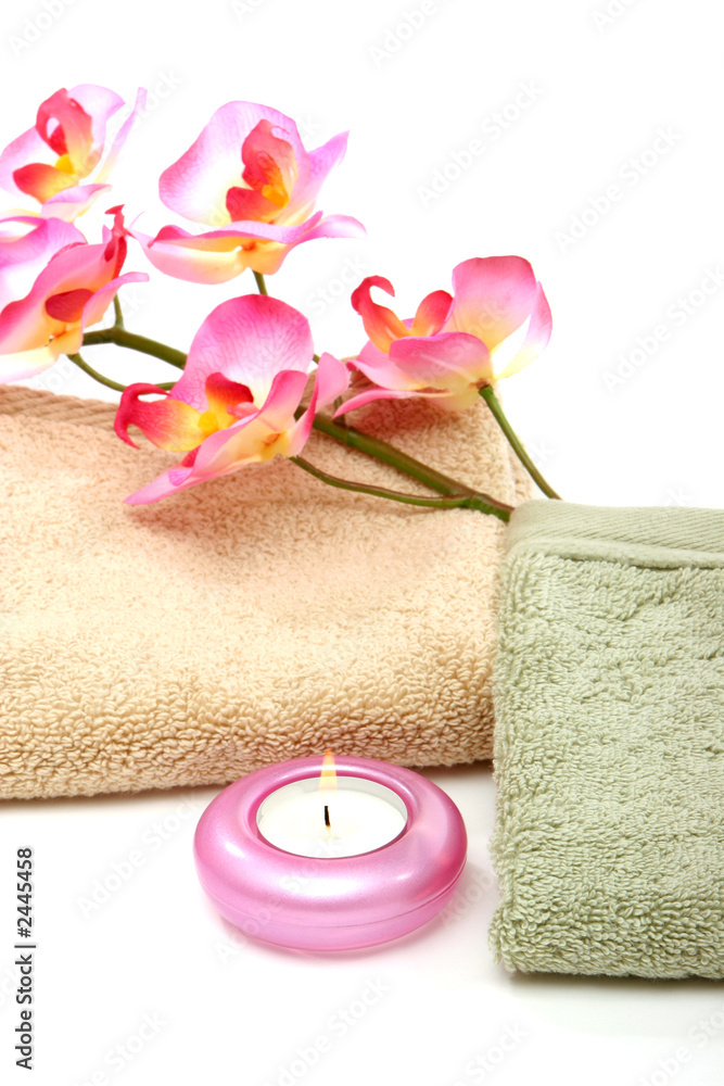 spa towels, candle and pink orchid