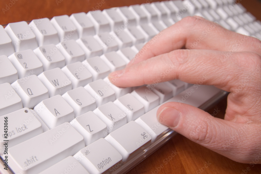 woman typing on a white computer keyboard woman typing on a white computer keyboard
