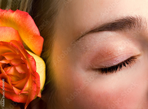 beautiful female closed eye and rose close-up