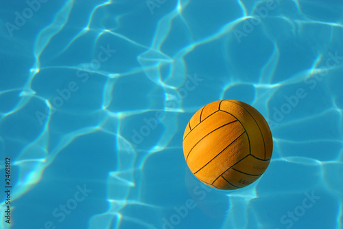 yellow waterpolo ball in blue pool