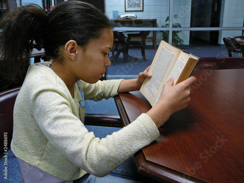 child reading in the library