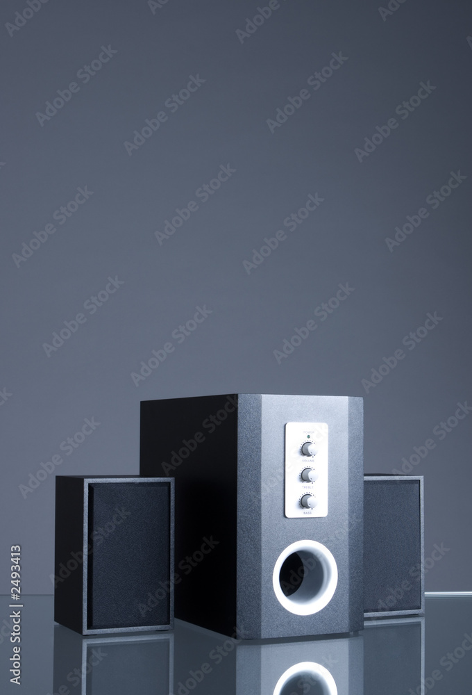 audio speakers on gray background with reflection