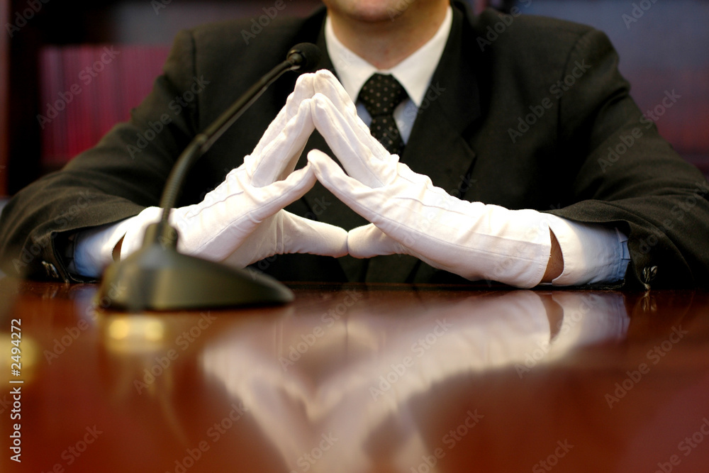 businessman with white gloves speaking