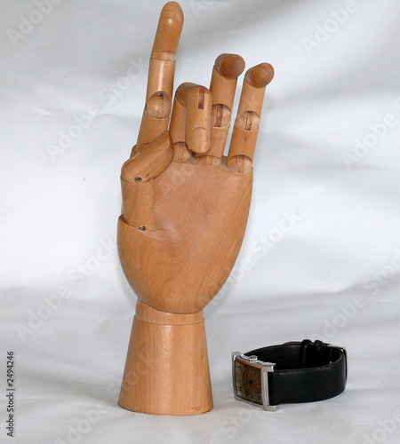 a wooden hand standing with watch