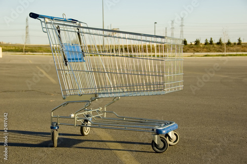 shopping cart sitting alone in a parking lot