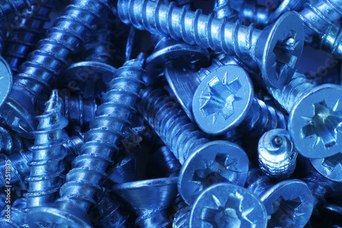 macro of small steel screws, with a cold tone