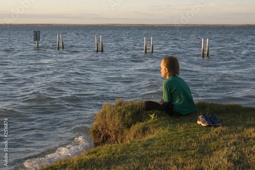 boy looking over lake