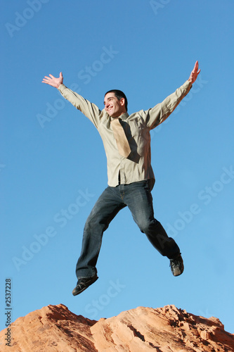 ecstatic business man jumping in the air