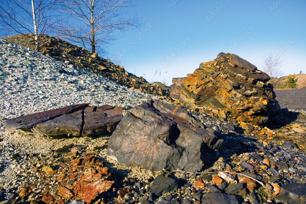 Obraz premium two stones at the bottom of striped hill with trees