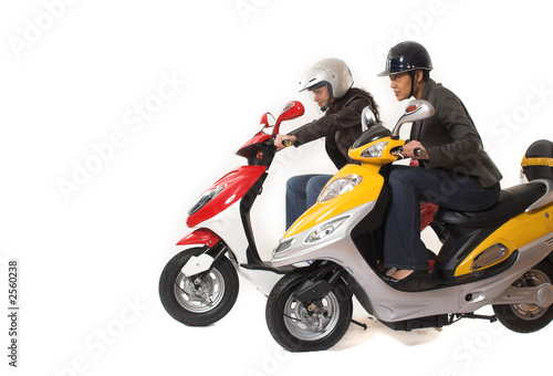 couple girls racing on electric scooter