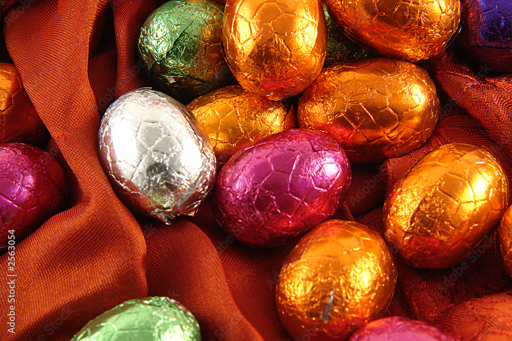 Obraz premium chocolate easter eggs on red background