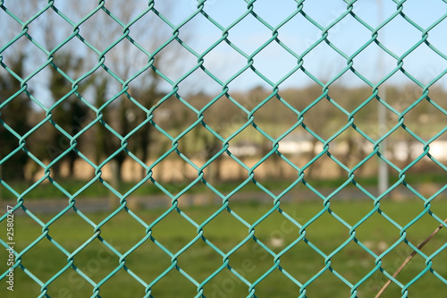 green chain link park fence close up.