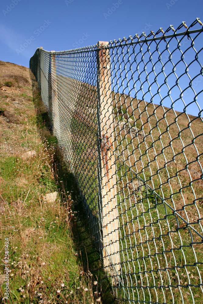 close view of a ong fence up a steep hill