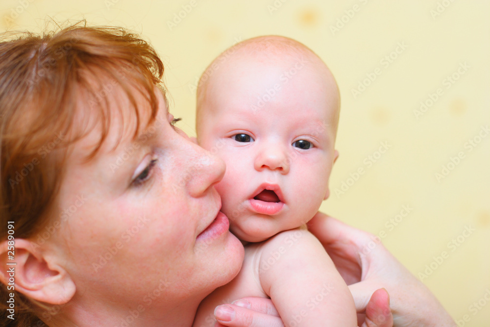 mother gently holding baby in hand mother gently holding baby in hand