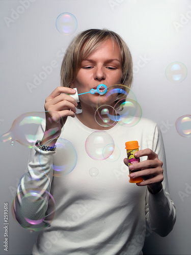 young woman blowing soap bobbles
