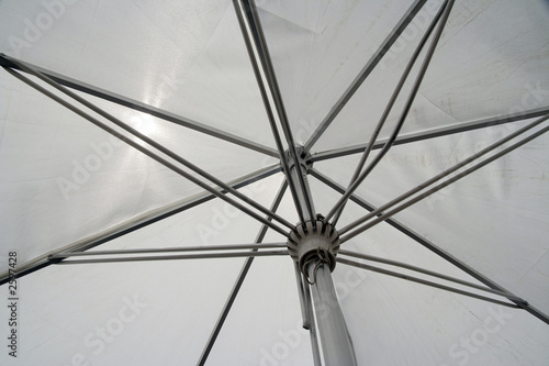 white umbrella with metal lines on a sunny day