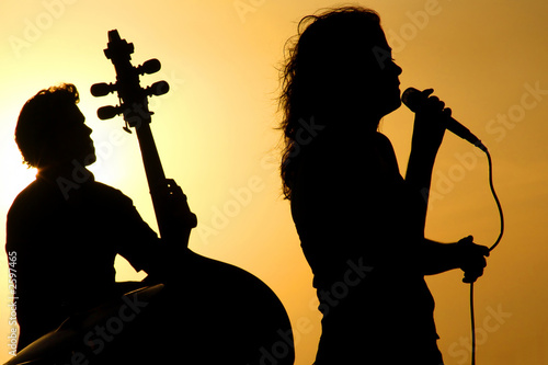 a singer and a stand up base silhouette