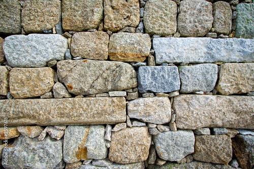 colorful and textured stone masonry wall useful for backgrounds