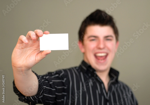 smiling young man with business card
