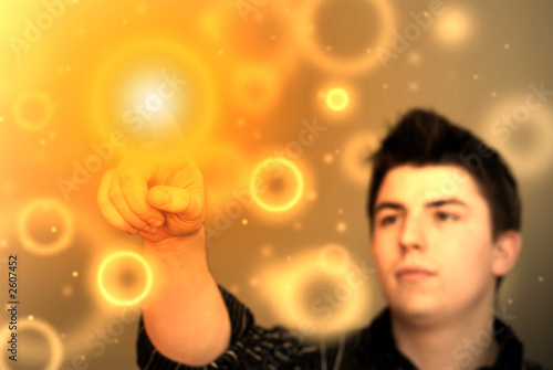 abstract image - young man touching glowing orange floating spot