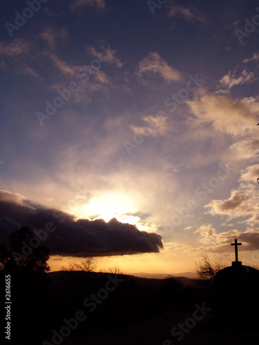stone cross in sunset