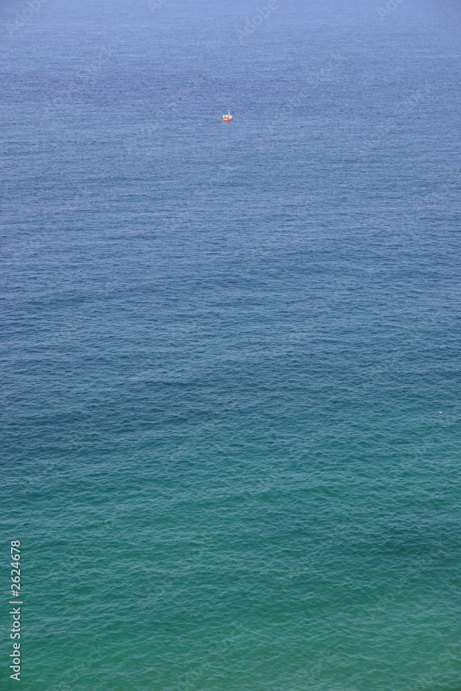 one small red fishing boat out at sea, cornwall, u