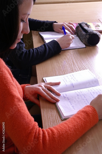 a student writing in the classroom