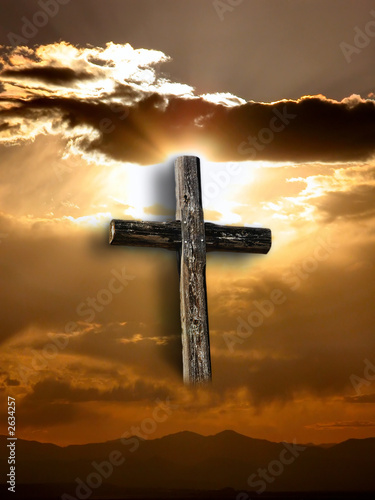 rugged cross with sunshine, clouds, and mountains