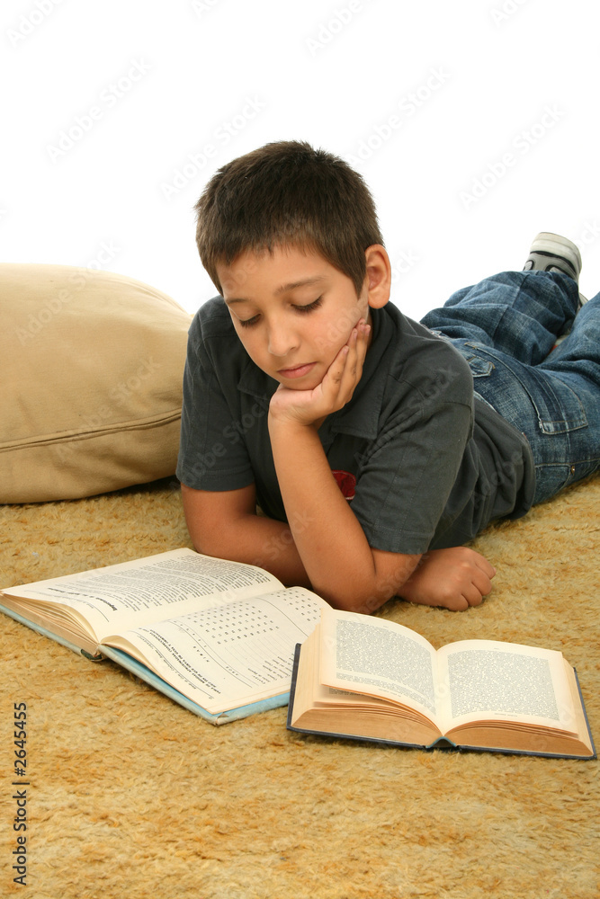 boy reading  books on the floor