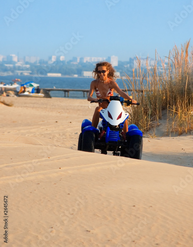 woman on motobike on the beach