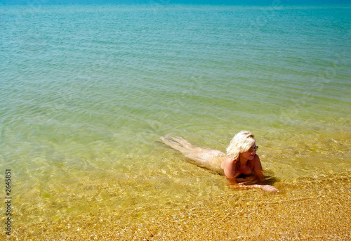woman lie in sea coast