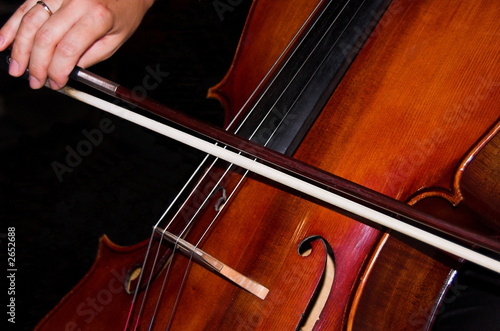 feminine hands playing cello