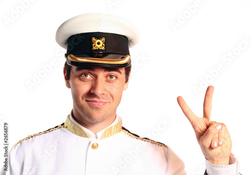 man in military sailer field uniform with hat saluting photo