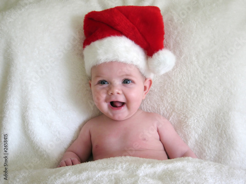 happy baby wearing santa hat