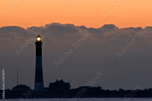 storm cloads and the lighthouse at sunrise