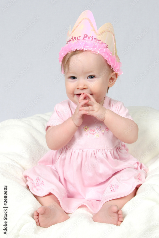 baby girl with birthday hat and hands together baby girl with birthday hat and hands together