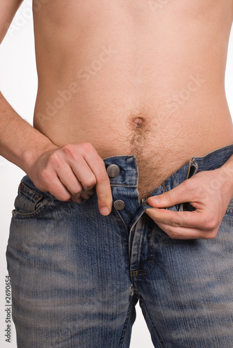 the man unbuttons trousers