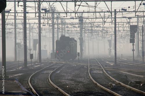 train in early morning fog in brugges, belgium photo