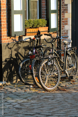 bicycles in front of house in brugges, belgium