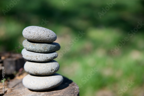 Photography zen stones balanced on log