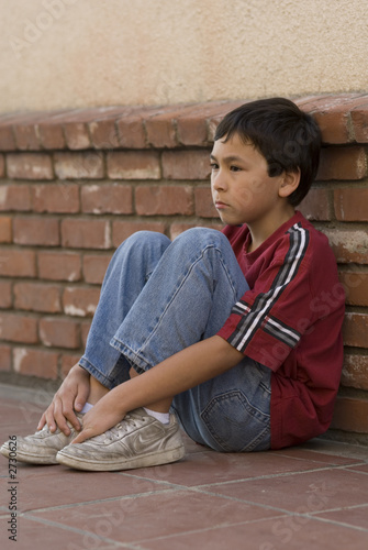 boy against brick wall