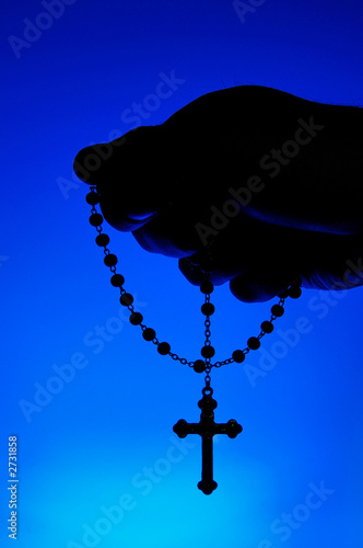 hand holding rosary