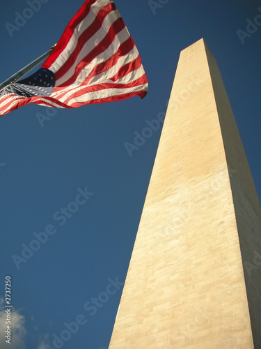 washington monument with the us flag on the wind on the national photo